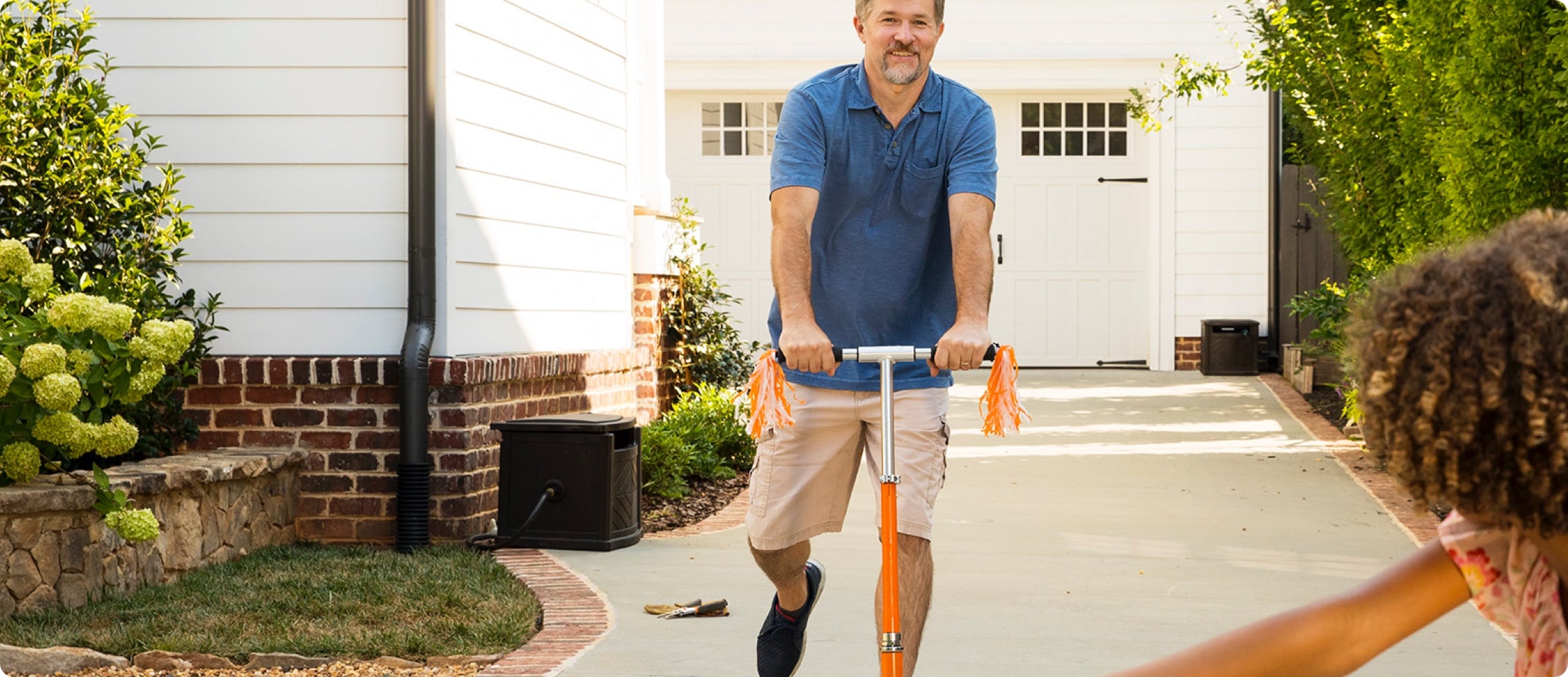 Child riding bike, adult riding scooter
