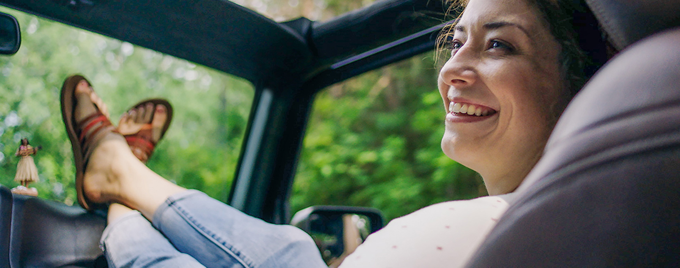 CIMZIA® patient smiling in the passenger seat of a car