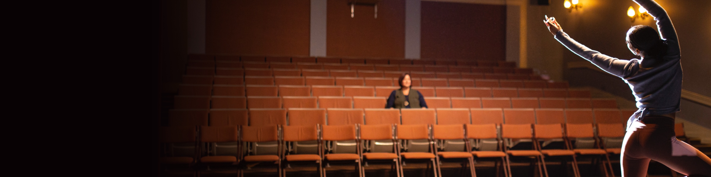 Lady in audience watching dancer on stage